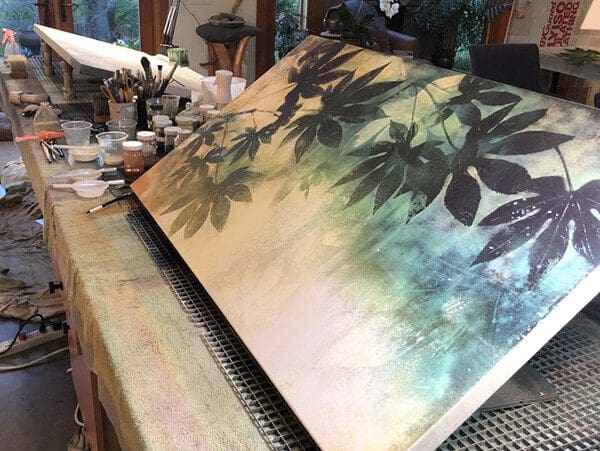 A painting of trees on top of a table.