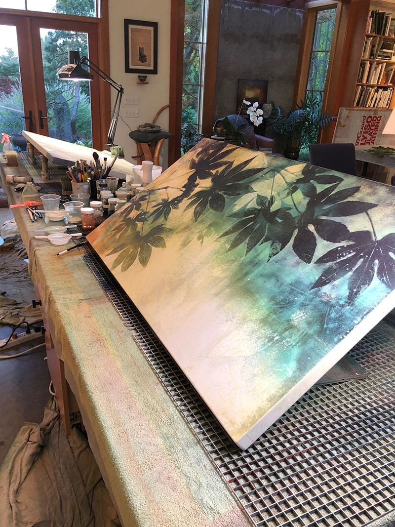 A painting of leaves on canvas being painted.