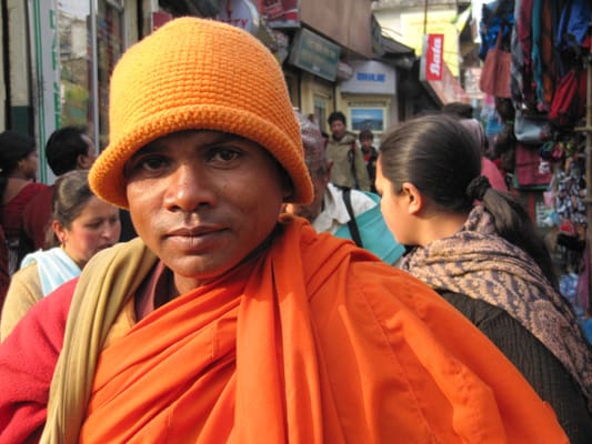 A man in an orange hat and scarf.