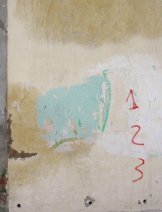 A wall with numbers painted on it