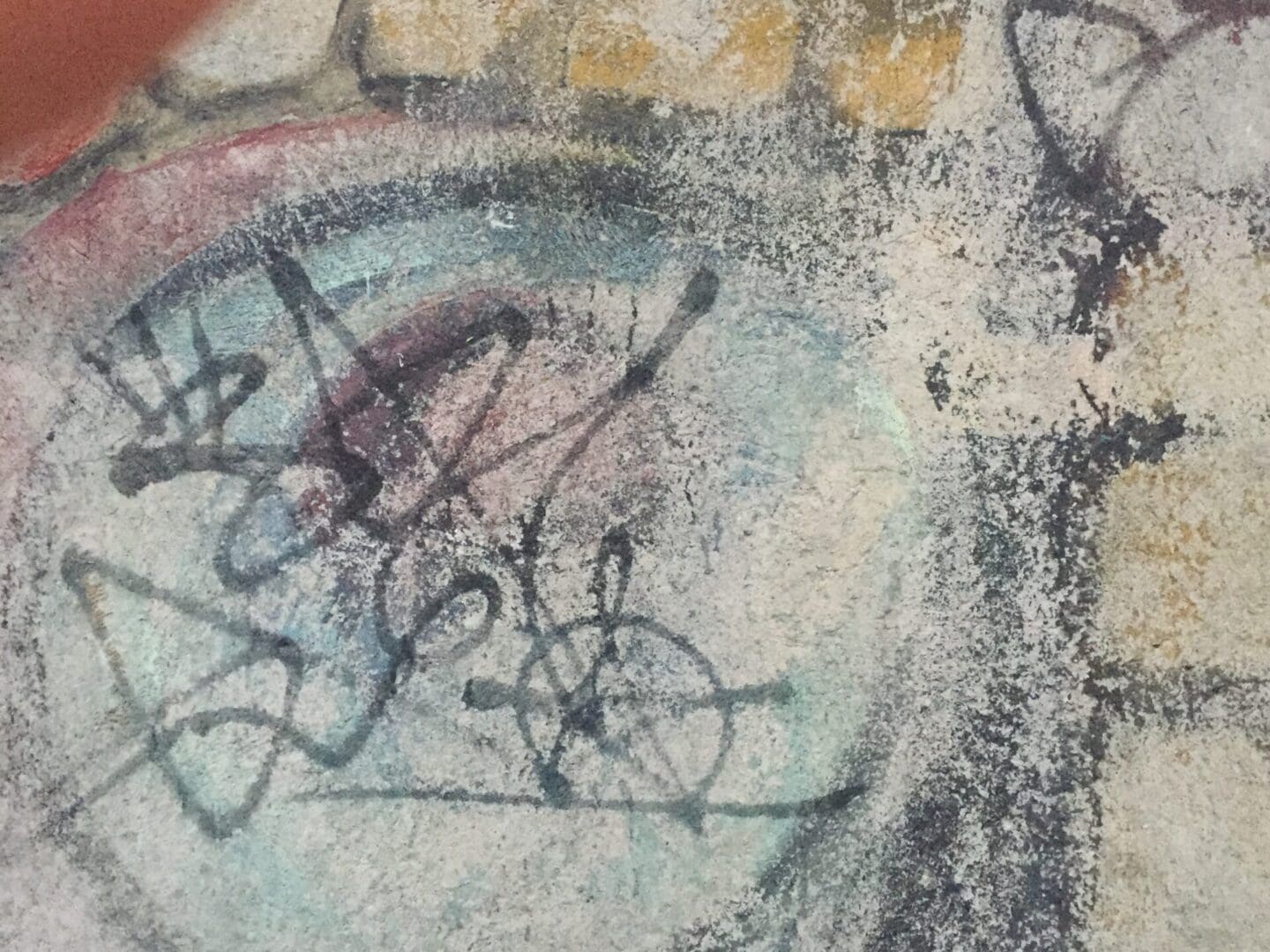 A close up of a painting with graffiti on it.