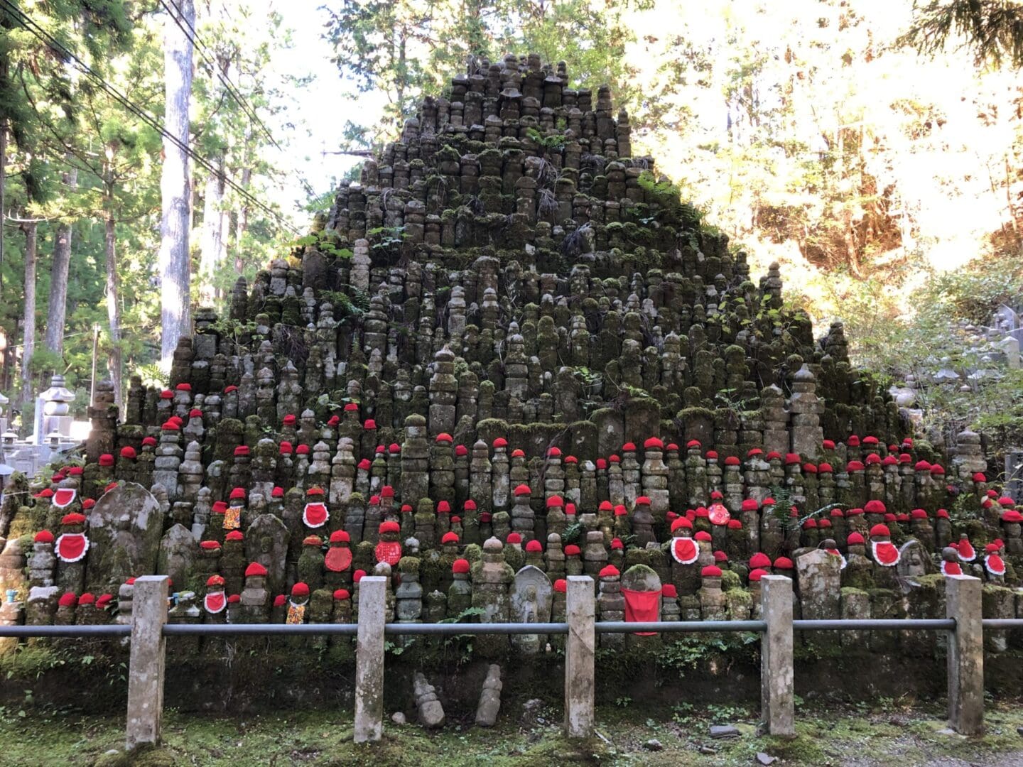 A large pile of rocks with red flowers on top.